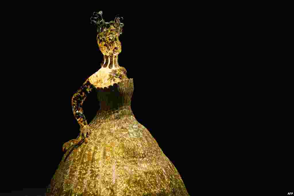 The "Little Magnificent Gold" creation by Chinese fashion designer Guo Pei, made with silk, gold and silver thread embroidery, is displayed during the "Au fil de l'Or, Art of the Dressing from East to the Rising Sun" exhibition at the Musee du Quai Branly in Paris, France.