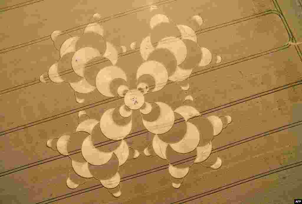 An aerial view shows people strolling through a crop circle on a field near Mammendorf, southern Germany.