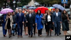 FILE - Supporters of Belgrade-backed Srpska Lista arrive at a polling station in the ethnically divided town of Mitrovica, Kosovo, Oct. 6, 2019. Kosovo's election appeals authority on Dec. 25, 2024, allowed Serb List to field candidates in the upcoming parliamentary election.