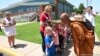 Children line up to meet and greet Buddhist monk Sutham Nateetong at Ziztman Elementary School during his journey walk across America to promote peace in Pacific, Missouri. May 22, 2019. 