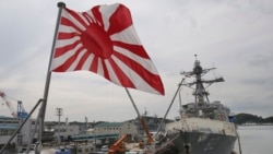FILE - In this May 27, 2014 photo, Japan's military flag, the Rising Sun Flag, flutters on the Japan Maritime Self-Defense Force tank landing ship JS Kunisaki anchored in Yokosuka near Tokyo, getting ready for participating in the Pacific Partnership 2014