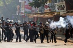 Riot police officers fire teargas canisters during a protest against the military coup in Yangon, Myanmar, February 28, 2021. REUTERS/Stringer NO RESALES NO ARCHIVE