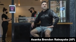 Director and founder of Black Velvet coffee shop Darren Silverman poses for a photo outside his cafe in Melbourne, Australia, Wednesday, Oct. 28, 2020. (AP Photo/Asanka Brendon Ratnayake)