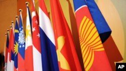 FILE PHOTO - The Association of the Southeast Asian Nations (ASEAN) flag, right, leads the flags of the 10-member countries during the ASEAN Regional Forum meeting in Singapore Wednesday, July 23, 2008.