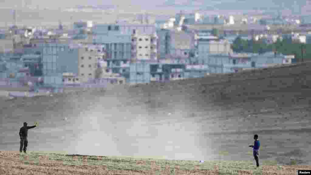 A Turkish soldier stops a man on a hill near the Mursitpinar crossing on the Turkish-Syrian border, Oct. 26, 2014. 