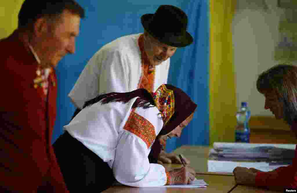People queue to receive their ballot papers at polling station in the village of Kosmach in the Ivano-Frankivsk region of western Ukraine.