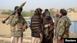 FILE - A group of Taliban fighters are seen in Ghazni province, Afghanistan, April 18, 2015. Officials in Afghanistan confirmed on July 8, 2018, the Taliban rocketed a high-profile emergency security meeting in the troubled southeastern Ghazni province, wounding at least two soldiers and several civilians.