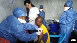 FILE - This handout photo released by Doctors Without Borders (MSF) Nov. 14, 2019, shows a young man receiving an Ebola vaccine at MSF facilities in the North Kivu capital of Goma, DRC.