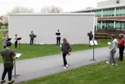 Students play instruments during a socially distanced band practice at Orefield Middle School in Orefield, Pennsylvania, April 12, 2021.