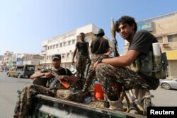 FILE PHOTO: Houthi militants patrol a street where pro-Houthi protesters demonstrated against the Saudi-led coalition in Hodeidah, Yemen Dec. 10, 2018
