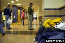 A student sleeps in the hallway of Hall Memorial Building on the campus of Gallaudet University on Friday, October 6, 2006, in Washington, DC.