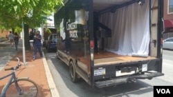 It only takes a few minutes for Luby and Zhang to turn their truck into their stage in the middle of the street.