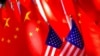 FILE - American flags are displayed together with Chinese flags on top of a trishaw in Beijing, Sept. 16, 2018.