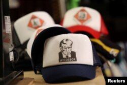 Hats with an image depicting the mug shot of former President Donald Trump are pictured after being printed at the Y-Que printing store in Los Angeles