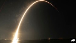 A Falcon 9 SpaceX rocket lifts off from the Cape Canaveral Air Force Station Complex 40 launch pad as seen through a time exposure in Cape Canaveral, Florida, Aug. 7, 2018.