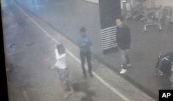 This image provided by Star TV of closed circuit television footage from Feb. 13, 2017, shows a woman, left, at Kuala Lumpur International Airport in Sepang, Malaysia, who police say was arrested Wednesday in connection with the death of Kim Jong Nam.