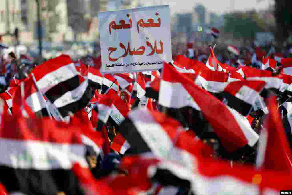 Supporters of prominent Iraqi Shi'ite cleric Moqtada al-Sadr shout slogans during a protest against corruption at Tahrir Square in Baghdad.