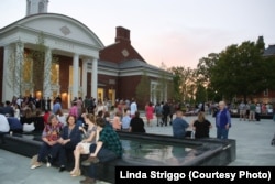 Parents and new students enjoy an event outside Hoover Dining Hall welcoming them to DePauw University.