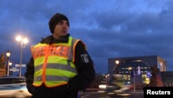 A policeman secures a street close to the Chancellery, the host of the Libya summit in Berlin, Germany, Jan. 18, 2020.