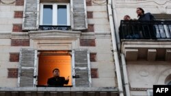 Keeping windows open can help move good air in and bad out. Here, French singer Stephane Senechal sings from his apartment's open window in Paris. A lockdown was imposed to slow the rate of the coronavirus disease (COVID-19) spread, March 24, 2020. REUTERS/Gonzalo Fuentes