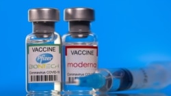 Vials with Pfizer-BioNTech and Moderna coronavirus disease (COVID-19) vaccine labels are seen in this illustration picture taken March 19, 2021.