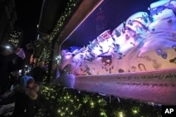 Macy' s Herald Square unveils its legendary Christmas windows celebrating the theme "The Perfect Gift Brings People Together," Thursday, Nov. 16, 2017, in New York. (Photo by Diane Bondareff/AP Images for Macy's)