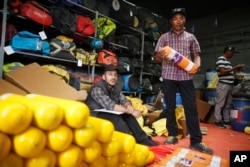 FILE - In this April 4, 2019, file photo, record holding Sherpa guide Kami Rita checks oxygen cylinders and other supplies needed for climbing Mount Everest, in Kathmandu, Nepal. (AP Photo/Niranjan Shrestha, File)