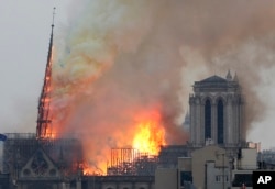 Flames rise from NoFlames rise from Notre Dame cathedral as it burns in Paris, Monday, April 15, 2019. Its tall, narrow spire later collapsed.
