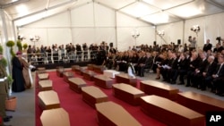 A funeral service for 24 migrants who drowned while trying to reach the Southern coasts of Italy. The funeral was held in Valletta, Malta on April 23, 2015. (AP PHOTO)