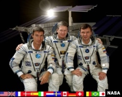 FILE - From left, Russia's Sergei Krikalev, American Bill Shepherd and Russia's Yuri Gidzenko are the first astronauts to live in the International Space Station in 2000. (Photo courtesy of NASA)
