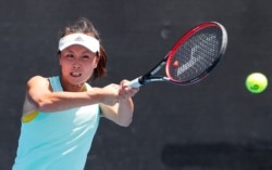 FILE PHOTO: China's Shuai Peng practices at the Australian Open at Melbourne Park, Melbourne, Australia, January 13, 2019.