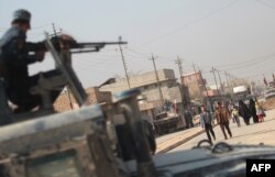 FILE - Iraqi forces patrol the Hammam al-Alil area, about 14 kilometres from the southern outskirts of Mosul, on Nov. 7, 2016, after recapturing it from Islamic State jihadists during the ongoing operation to retake Mosul.