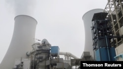 Water vapour rises from a cooling tower of a China Energy ultra-low emission coal-fired power plant during a media tour, Feb. 2, 2021.