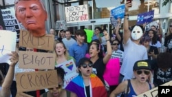 Protesters hold banners during a rally in opposition to President-elect Donald Trump, in the Hollywood section of Los Angeles, California, Nov .13, 2016. Rallies in various U.S. cities entered their fifth day on Sunday. 
