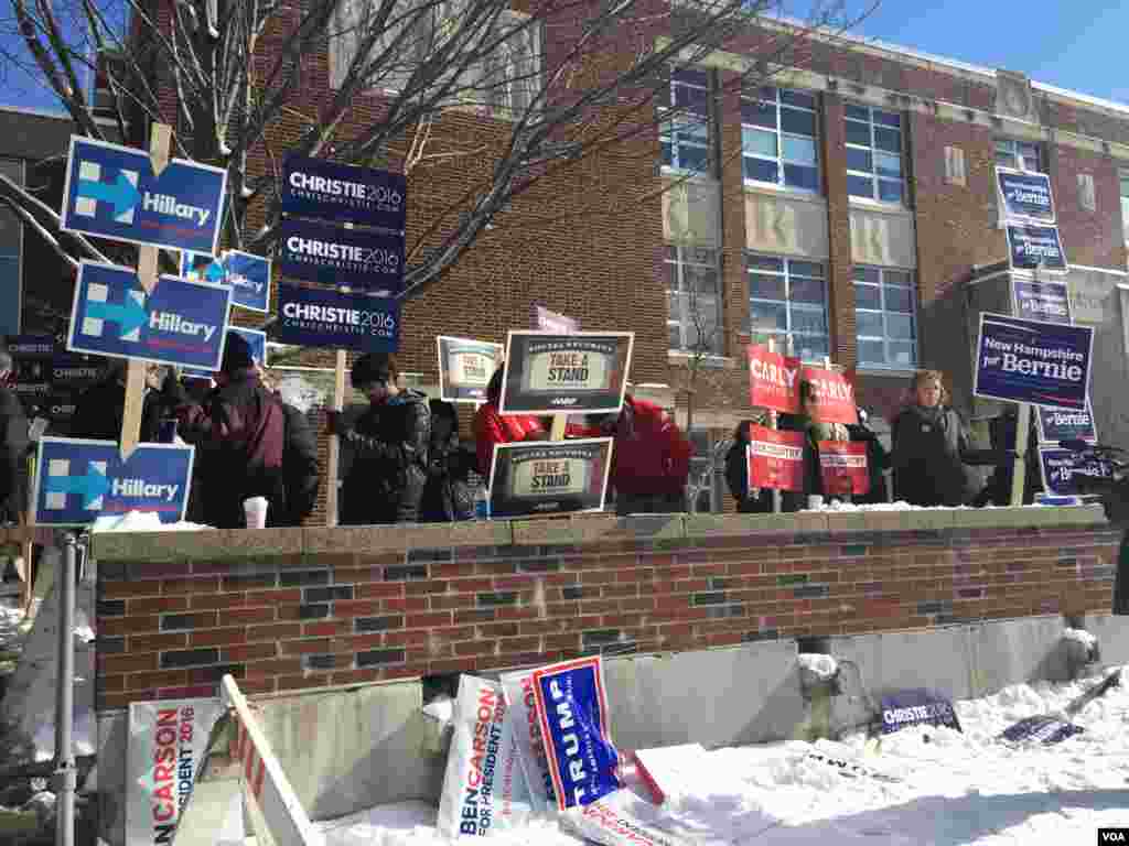 Candidates' posters on display in front of a polling station in Ward 1, Manchester, New Hampshire, Feb. 9, 2016. (Photo: K. Gypson / VOA)