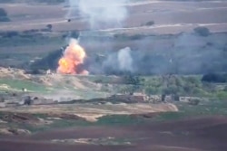 This image taken from a video released by Armenian Defense Ministry on Sept. 28, 2020, allegedly shows fighting between Armenian and Azerbaijani forces at the contact line of the self-proclaimed Republic of Nagorno-Karabakh, Azerbaijan.