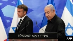 Israeli Prime Minister Benjamin Netanyahu (R) and French President Emmanuel Macron (L) arrive to hold a joint press conference in Jerusalem on October 24, 2023.