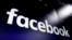 FILE - In this March 29, 2018, file photo, the logo for Facebook appears on screens in New York's Times Square. Facebook is defending itself against allegations that it allows illegal content in violation of Vietnam’s cybersecurity law. The social…