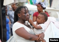 Una mujer sostiene a un bebé en un estadio deportivo donde se han refugiado de la violencia, en Puerto Príncipe, Haití, el 1 de septiembre de 2023. REUTERS/Ralph Tedy Erol