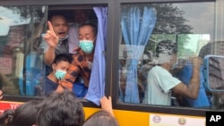 FILE - Released prisoners on a bus leave from Insein Prison in Yangon, Myanmar Wednesday, May 3, 2023.