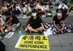 Hong Kong protesters in Taiwan and Taiwanese supporters gathered to mark the first anniversary of a mass rally in Hong Kong against its now-withdrawn extradition bil at Democracy Square in in Taipei, Taiwan, Saturday, June 13, 2020. (AP Photo/Chiang)