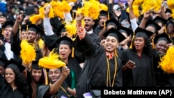 Graduating students in the Class of 2016 at City College of New York cheer.