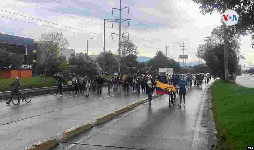 Bajo la lluvia, colombianos marchan por una vía de la capital Bogotá, protestando una impopular propuesta de reforma tributaria. Domingo 2 de mayo de 2021.