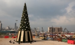 FILE PHOTO A Christmas tree with names of those who died during Beirut port explosion, is seen near the damaged grain silo, in Beirut, Lebanon December 22, 2020. REUTERS/Mohamed Azakir