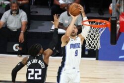 Nikola Vučević šutira preko centra Sakramento Kingsa Rišona Holmsa (22) u Orlandu, 2. avgusta 2020. (Foto: AP/Kim Klement)