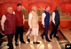 FILE - Leaders of BRICS nations, from left, Brazilian President Michel Temer, Chinese President Xi Jinping, Indian Prime Minister Narendra Modi, Russian President Vladimir Putin and South African President Jacob Zuma are seen prior to dinner hosted by Modi in Goa, India, Oct. 15, 2016. Of the five nations, three are not sending their heads of governments to the upcoming OBOR program, according to the list released by the Chinese foreign minister.