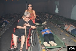 Rosario "Charito" Planas, political opponent of dictator Ferdinand Marcos and herself a detainee, passes through the "Hall of Restless Sleep," a dramatization of political detainees in captivity. EDSA Revolution Experiential Museum, Quezon City, Feb. 24, 2016.