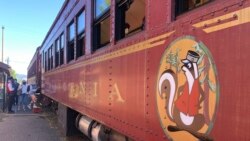 People get on the Skunk Train in Willits, Calif., Wednesday, Aug. 4, 2021. Robert Pinoli, president of Mendocino Railway, which owns the Skunk Train, said he is ready to help. Pinoli said he could find tank cars quickly and attach them to the train to deliver water to the town. (AP Photo/Haven Daley)