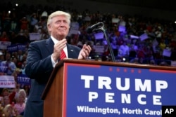 Republican presidential candidate Donald Trump applauds during a campaign rally at the University of North Carolina-Wilmington, Aug. 9, 2016.