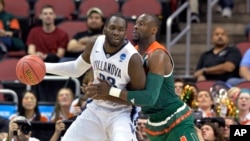 Villanova forward Daniel Ochefu (23) is guarded by Miami center Tonye Jekiri